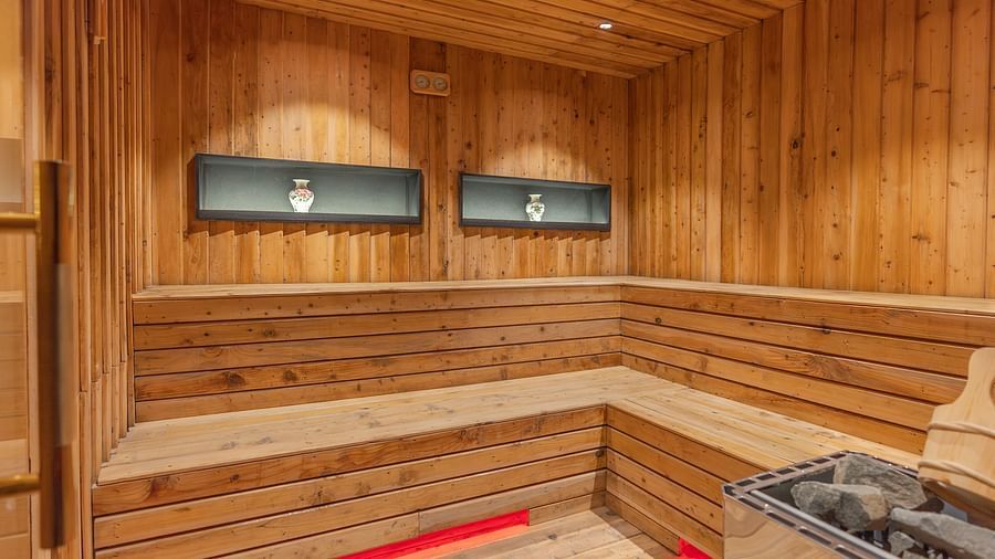 alt-text An image of the Sauna with a seating arrangement for relaxation - The Manor Luxury Hotel, Shimla