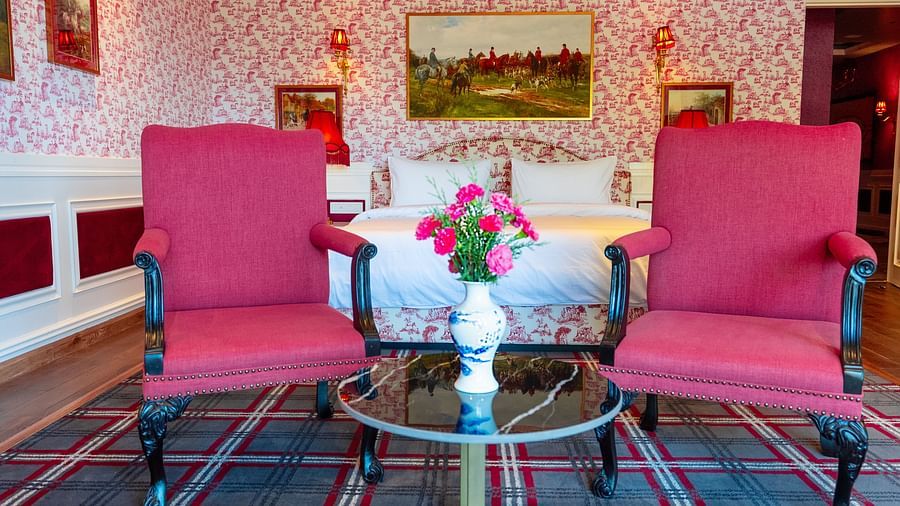 An image of two comfy red chairs in one of our rooms  - The Manor Luxury Hotel, Shimla
