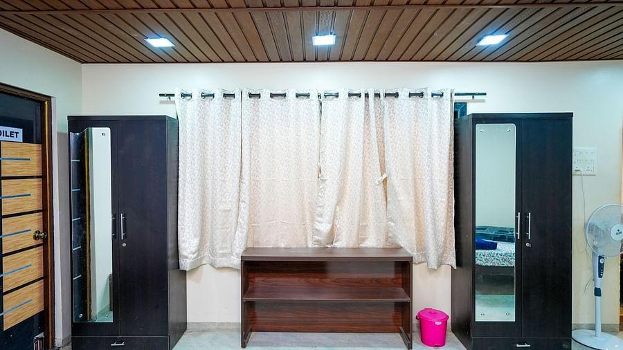 Interior view of a hostel lobby with wooden benches and lockers | Diamond Parks, Pune 