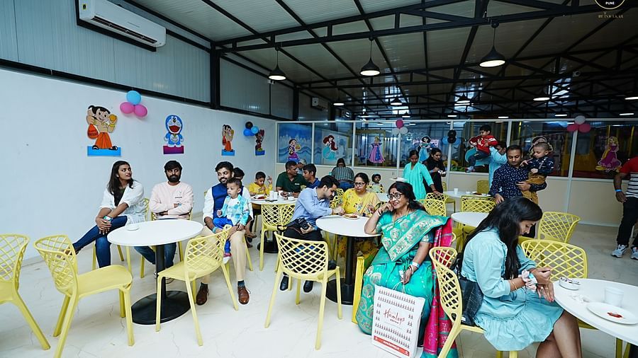 a group of people sitting in a large room - Diamond Parks, Pune 