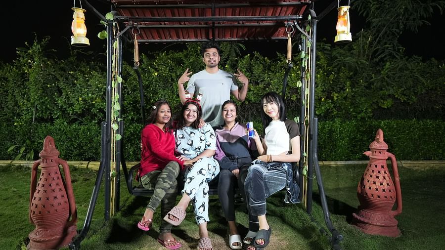 Group of friends posing for a photo on a swing in a garden at night | Diamond Parks, Pune.