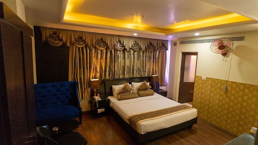 A large bed in a Deluxe Room at Hotel Ashok Nagpur.