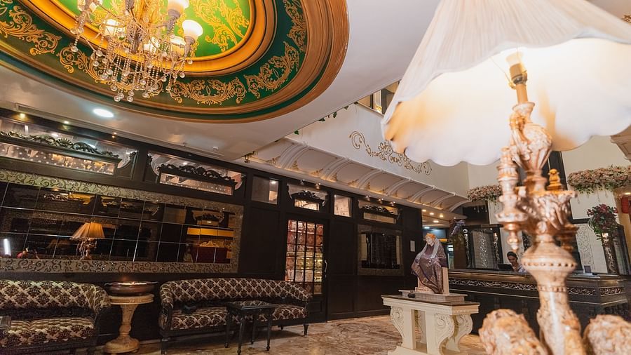 Hotel Ashok Nagpur featuring a decorative sculpture in the lobby and a glimpse of the reception area. 