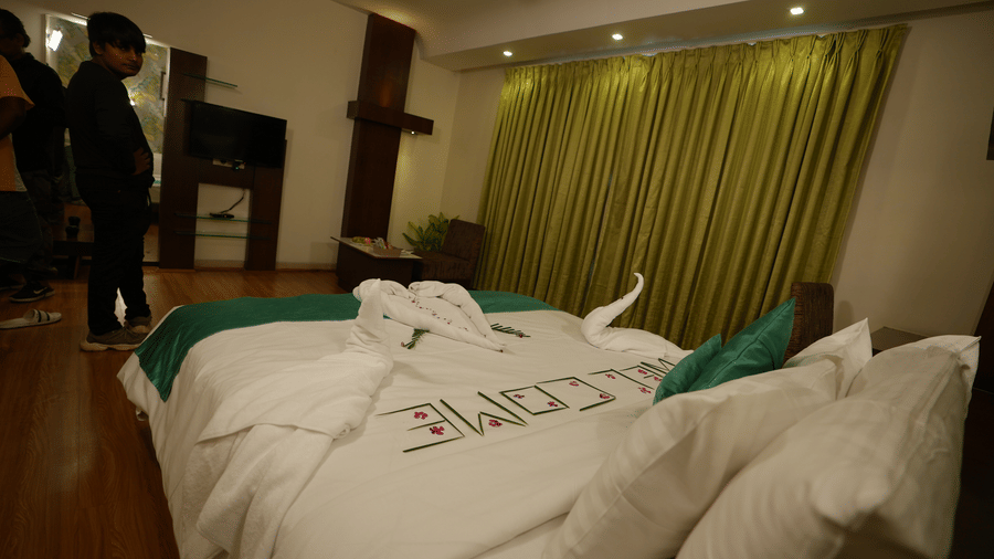 Spacious guest room with a bed and warm lighting at Pipul Utkal Continental, Jharsuguda.