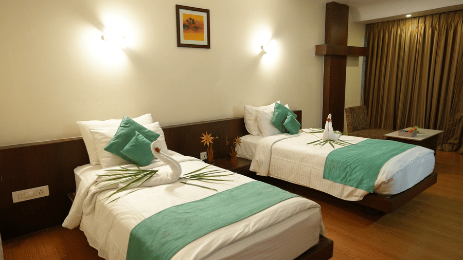 Bedroom with comfortable bedding and elegant interiors at Pipul Utkal Continental, Jharsuguda.