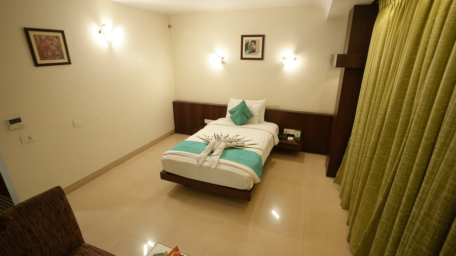 Comfortable hotel room with curtains and cosy interiors at Pipul Utkal Continental, Jharsuguda.