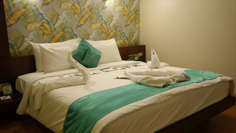 Elegant hotel room with neatly arranged bed and modern decor at Pipul Utkal Continental, Jharsuguda.
