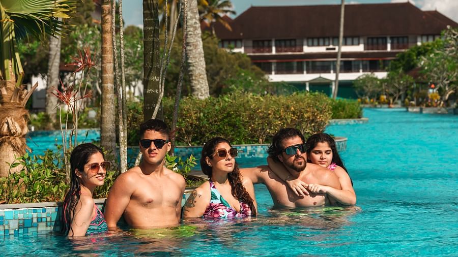 an image of a group of people in pool posing for a picture - Rhythm Kumarakom
