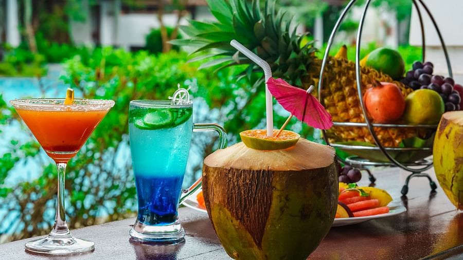 Rhythm Kumarakom - Mocktails on a table with a fruit basket