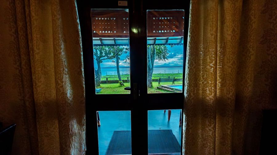 Rhythm Kumarakom - a glass door leading out to the garden in our resort