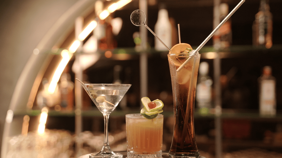Assortment of handcrafted cocktails served at Trino Bar with stylish glassware