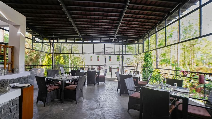 Full view of the dining area with table and chairs set at WOW Bungalow, Yercaud. 