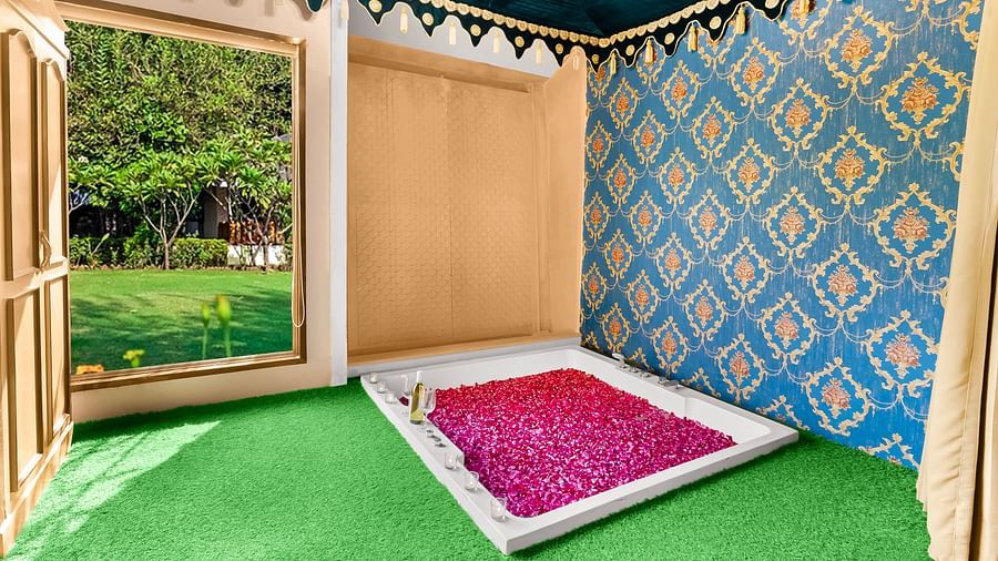 An overview of a bathroom with a bathtub filled with rose petals - Rajasthali Resort & Spa, Jaipur.