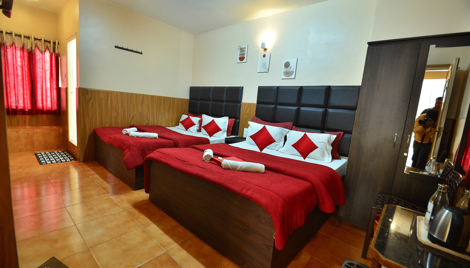 Image of a room with two beds and a wardrobe in the corner at BN Tourist Home.
