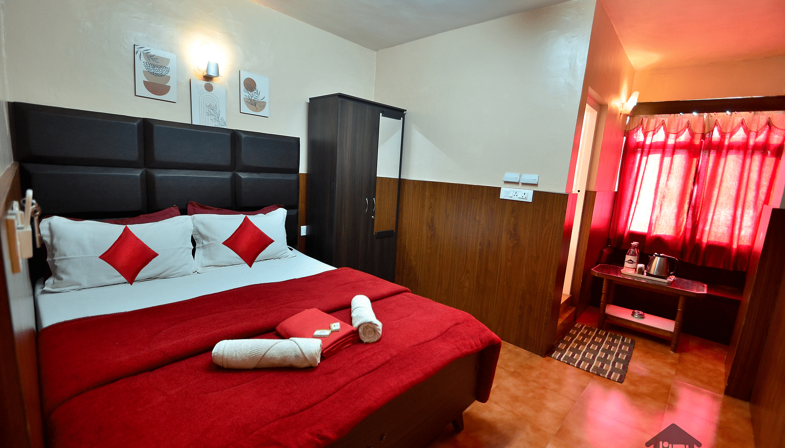 Image of a room with a double bed and a wardrobe on the side at BN Tourist Home, Ooty