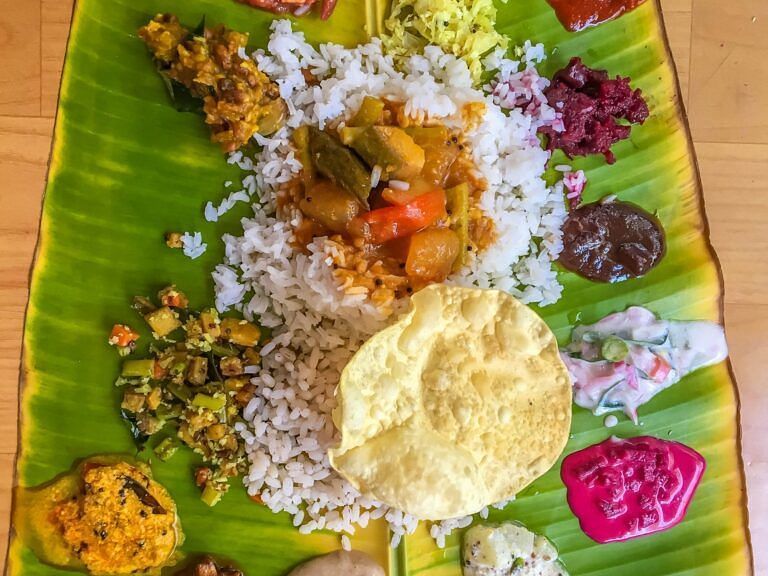 Traditional South Indian meal served on a banana leaf with a variety of dishes.