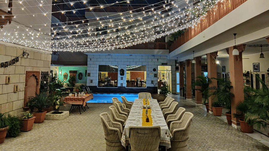 Seating arrangement with fairy lights on the top at Al-fresco Dinner at the courtyard at Suryaa Villa Jaipur