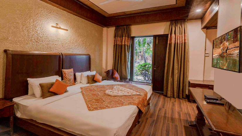 A light-filled room with light-blue walls and white shiplap, featuring a large white wooden bunk bed and a natural wood dresser.