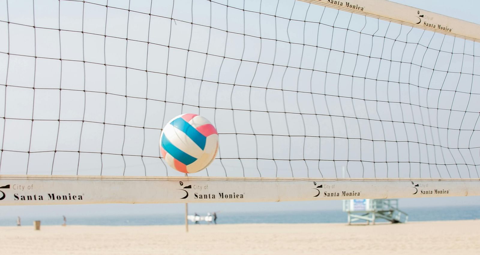 a volleyball court on a sandy beach on a bright sunny day