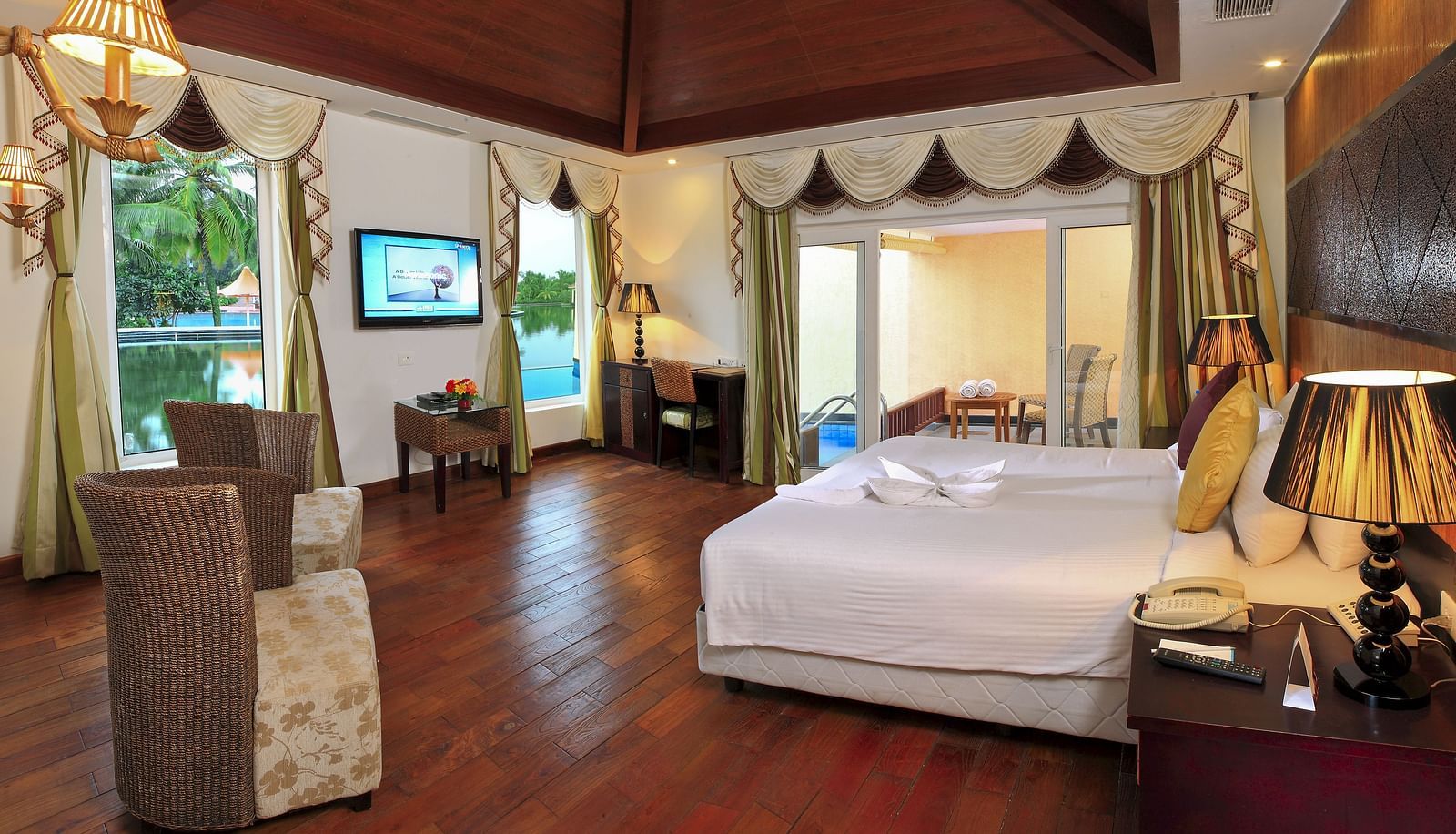 Bedroom with a bed and floor-to- ceiling window at Ocean Spray Puducherry