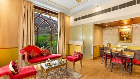 An overview of a living room with sofas, table and a dining table inside it - Rajasthali Resort & Spa, Jaipur.