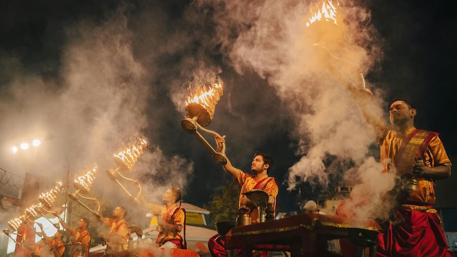 Image of priest doing Ganga Aarti by the bank of river Ganges at the evening.