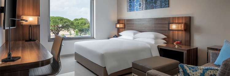 Standard king room featuring a bed, couch, television and a working area at The Residency Towers Rameswaram