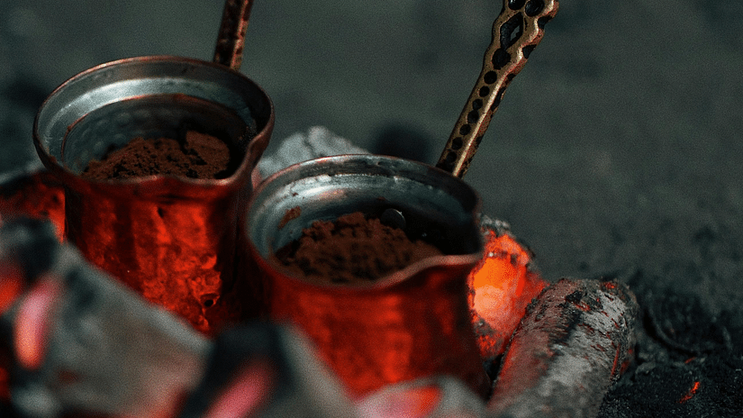 Ground coffee beans in a copper vessel