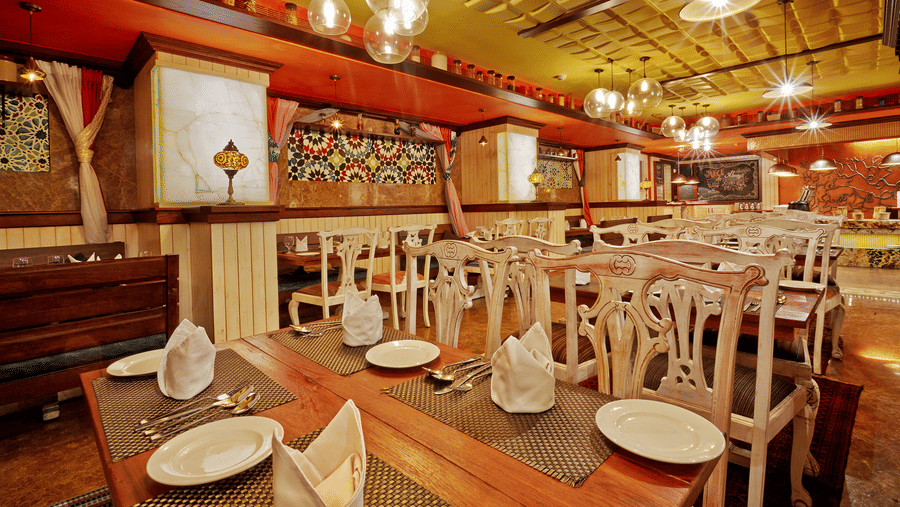 Dining tables with chairs at The Spice, a popular buffet restaurant in Chennai, located at Hablis Hotel.