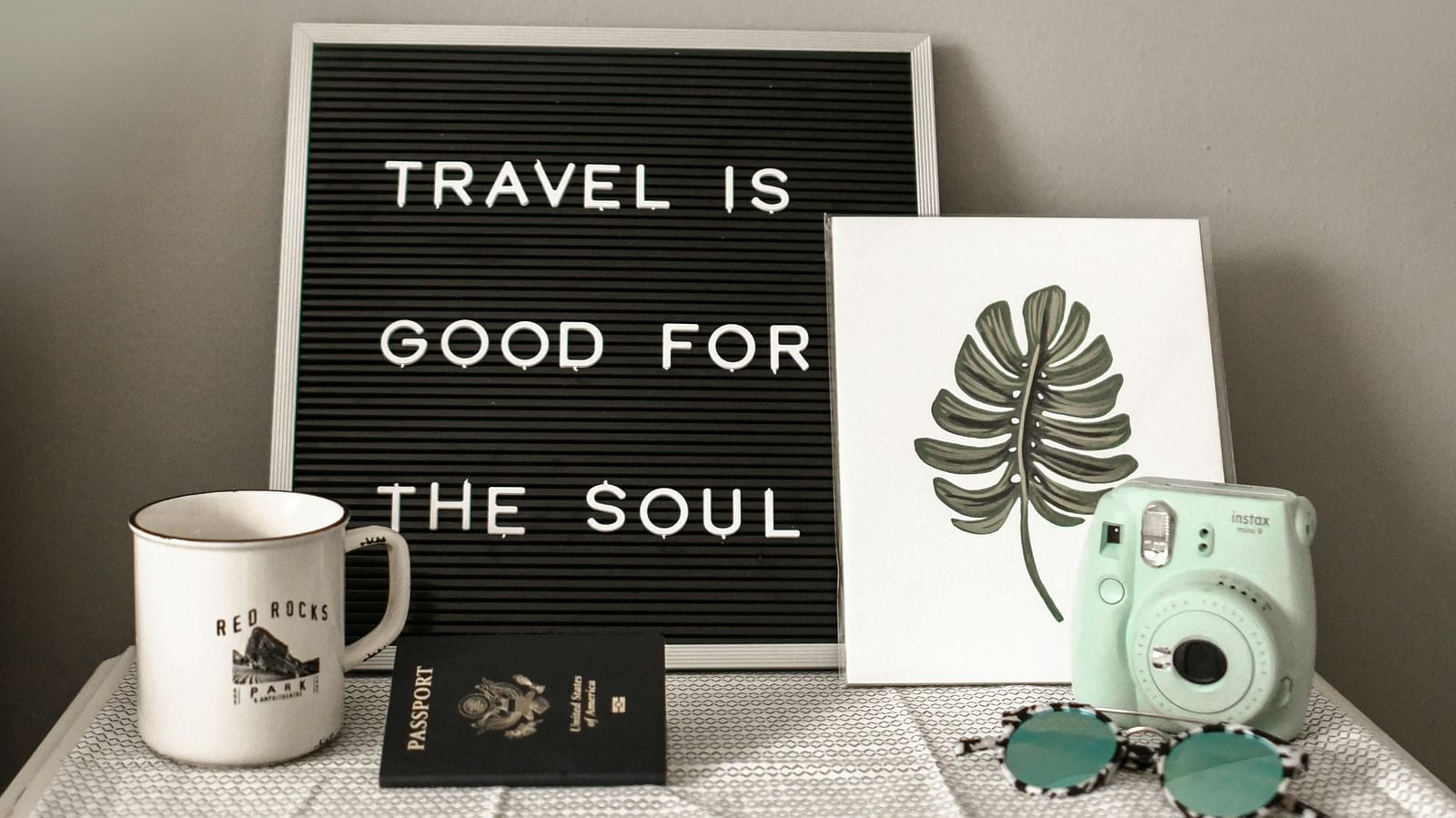 Image of a black board that talks about a travel with a polaroid camera.