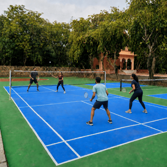 Badminton-Indian friends play doubles badminton-Resorts Near Delhi NCR.jpg