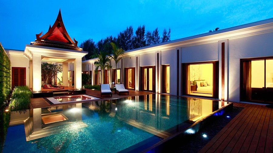 exterior images with swimming pool and well lit lights on a late evening - two bedroom private pool beachfront villa