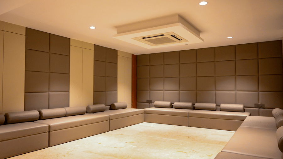 A minimalist spa lounge with long, comfortable cushioned bench seating along the walls - Praveg's Grand Eulogia, Ahmedabad