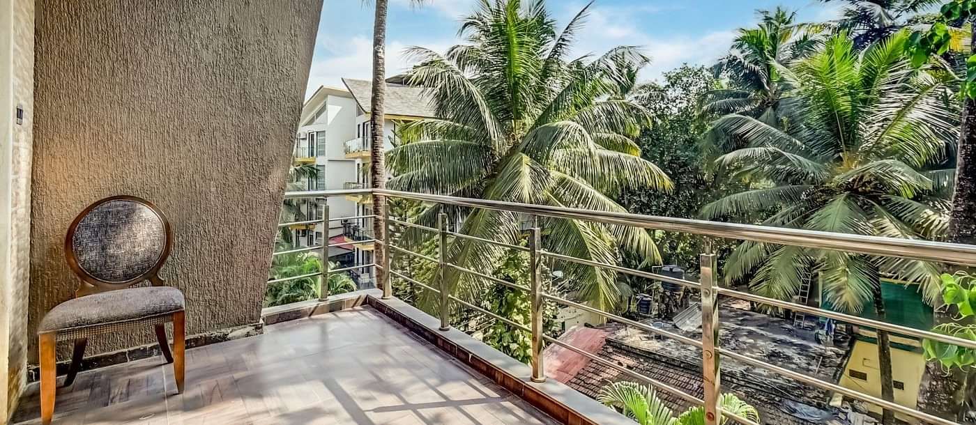 Balcony offering a delightful view of the lush, green coconut trees