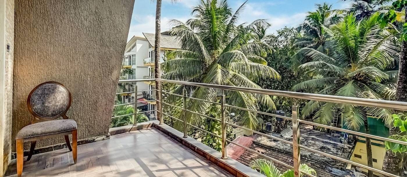 Balcony offering a delightful view of the lush, green coconut trees