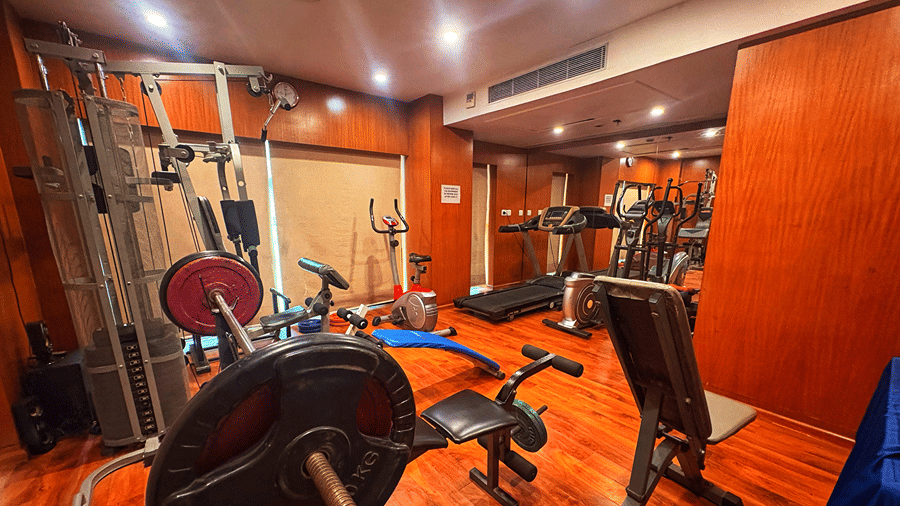 The gym at the Senses Hotel with wooden flooring with several machines and fitness equipments.