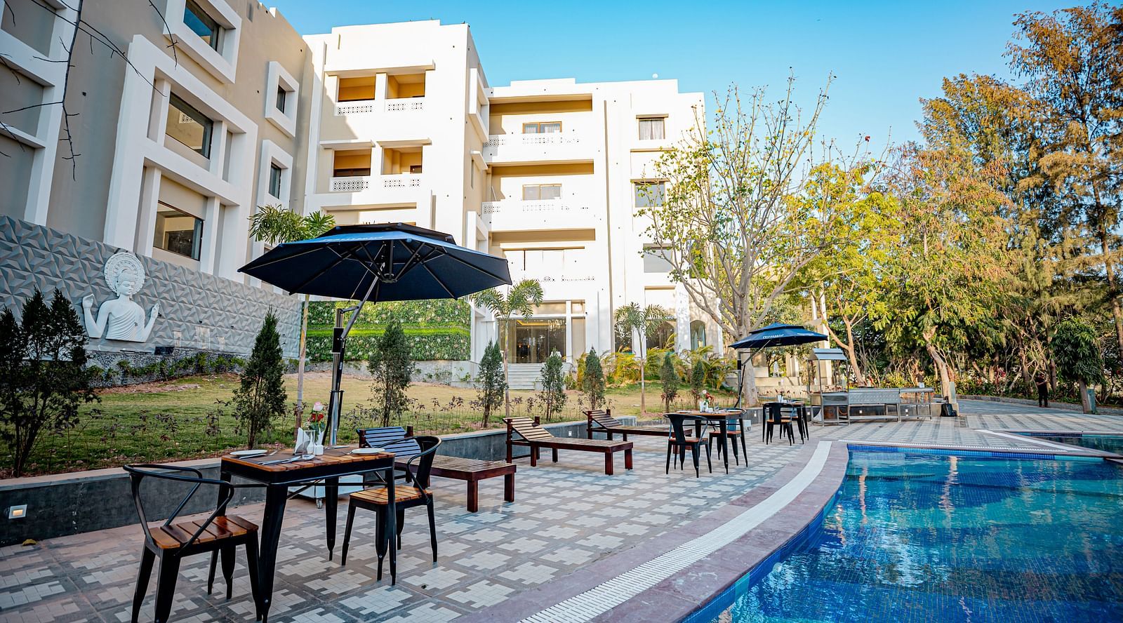 Image of a pool with seating area on the side at Essentia Luxury Resort and Spa, Udaipur