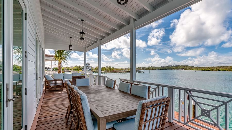 Outdoor dining space on a covered porch with ocean views | Abaco Inn