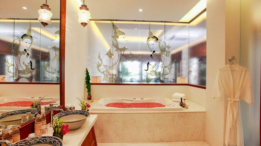 image featuring a full length bathtub with rose petals in it - one bedroom private pool beachfront villa
