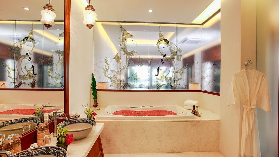 image featuring a full length bathtub with rose petals in it - one bedroom private pool beachfront villa