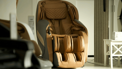 A massage chair with a quilted pattern placed beside a small side table