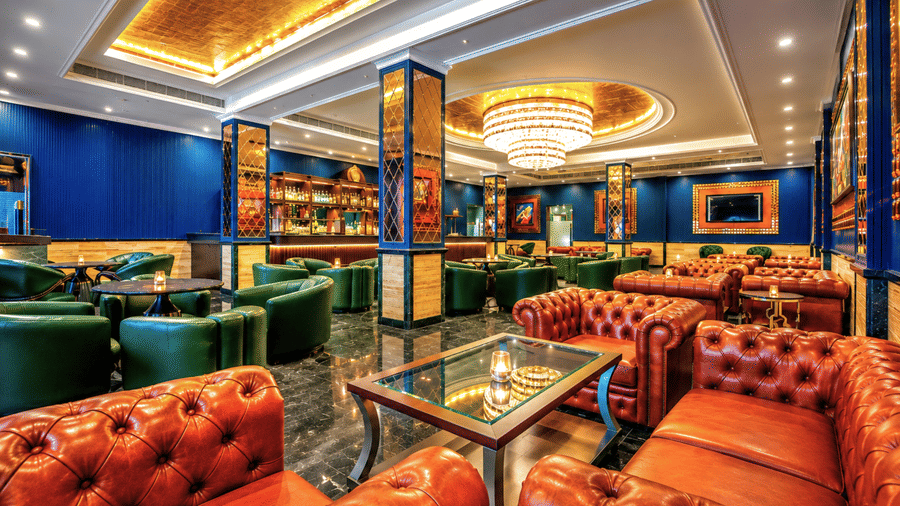Baron & Baroness Bar with leather seating and vibrant décor at Mayfair Oasis Resort, Jharsuguda