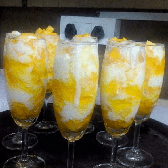 Refreshing dessert glasses with layered fruit and cream presentation at Central Courtyard Boutique Hotel.