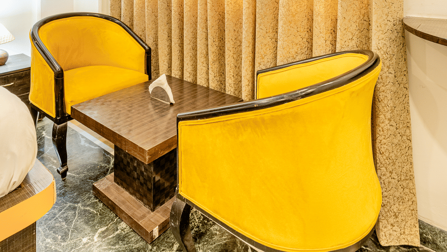 Two chairs facing each other in the superior double or twin room at Lime Tree Hotels and Banquet Hall Near Huda Metro, Gurgaon