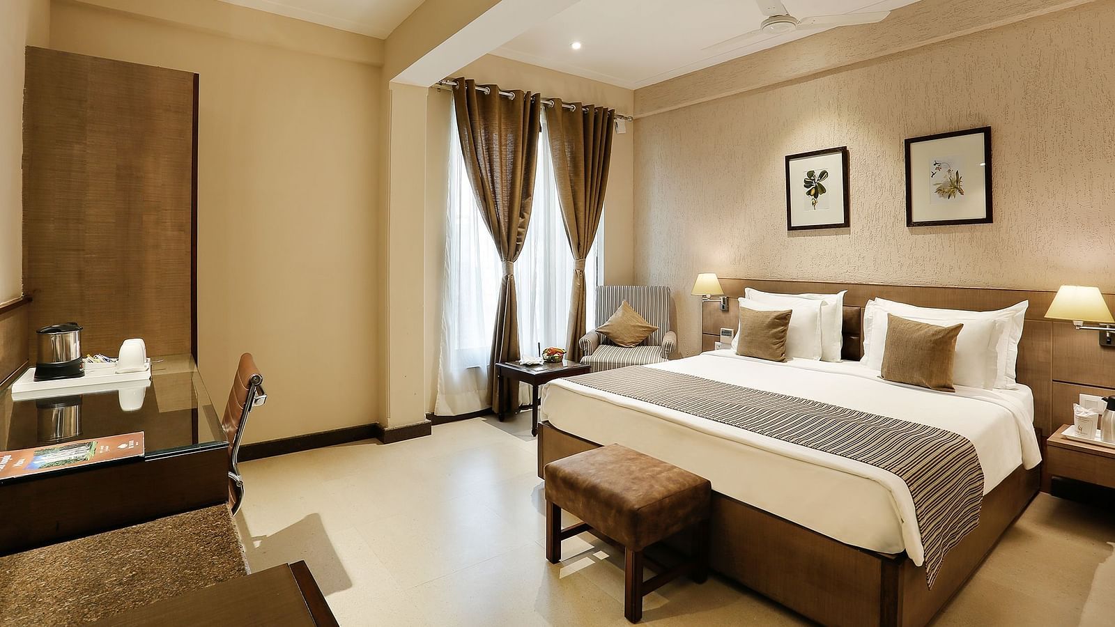 an image of suite at The Manor in Bareilly, featuring a plush bed and a stylish tea/coffee maker