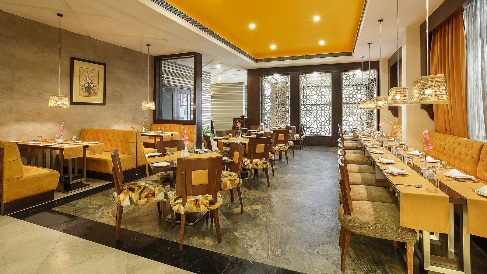 A spacious dining space with wooden chairs and a buffet setup ready to welcome guests for a meal - The Manor, Bareilly