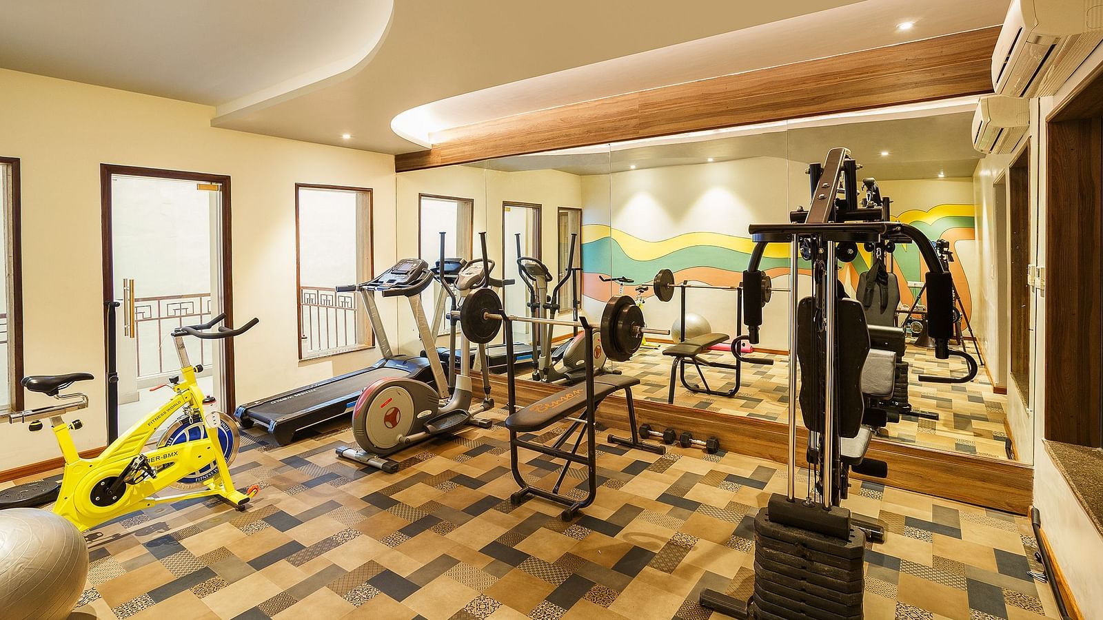 A modern gymnasium with equipment to work out - The Manor, Bareilly