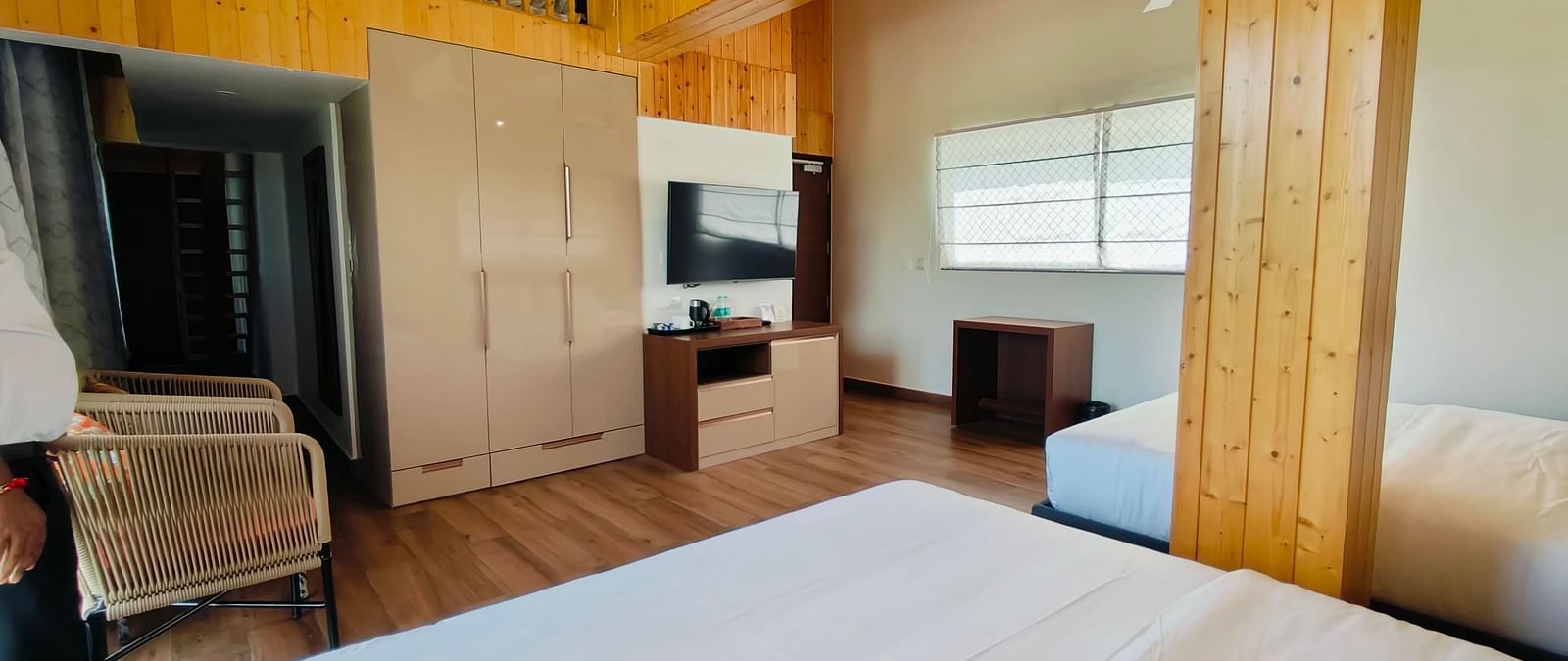a family suite with wooden interiors at Eminence The Corbett with two beds in the room