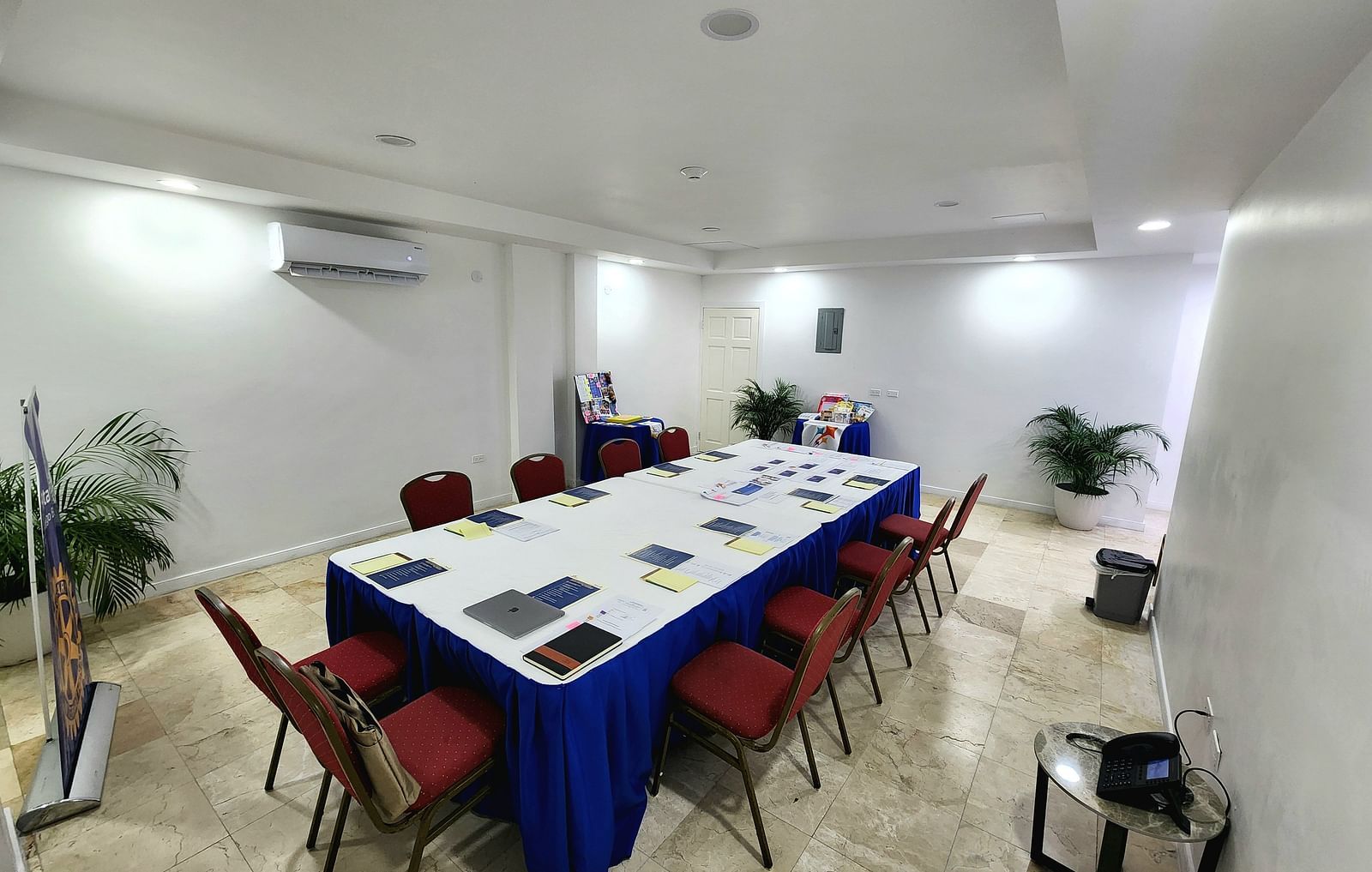 A clean, modern meeting space in Montego Bay with red chairs and a white conference table - Hotel 39, Jamaica (Montego Bay)