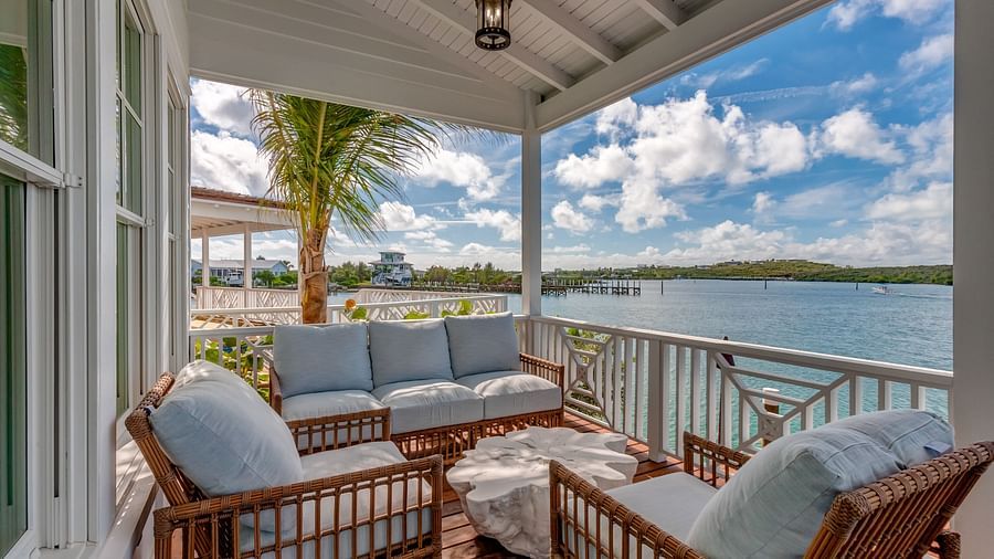 Covered balcony with plush seating and sea views | Abaco Inn